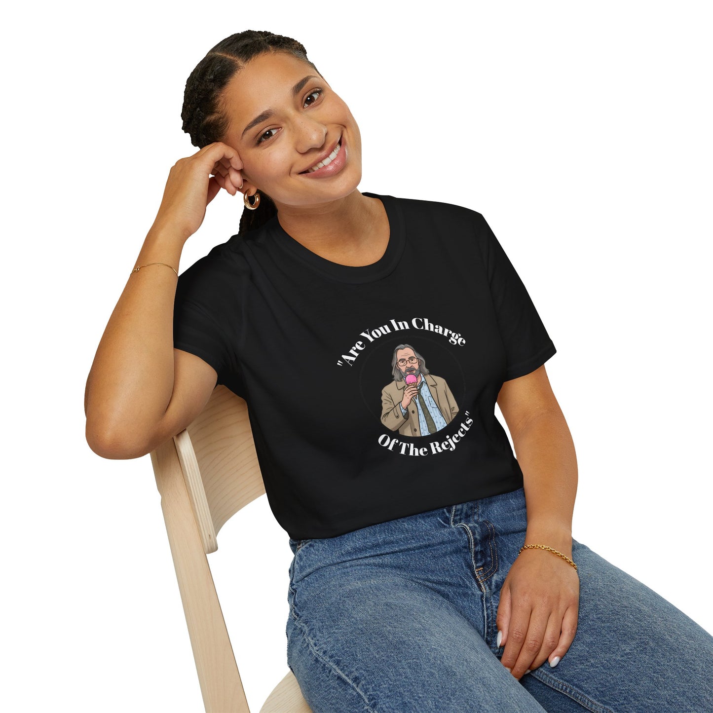 A woman wearing a black t-shirt with a Jackson lamb graphic and text, sitting on a chair.