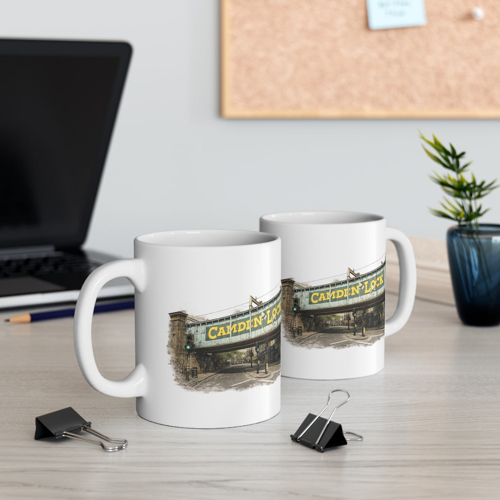 Two mugs with a Camden Lock design on a desk with office supplies and a plant.