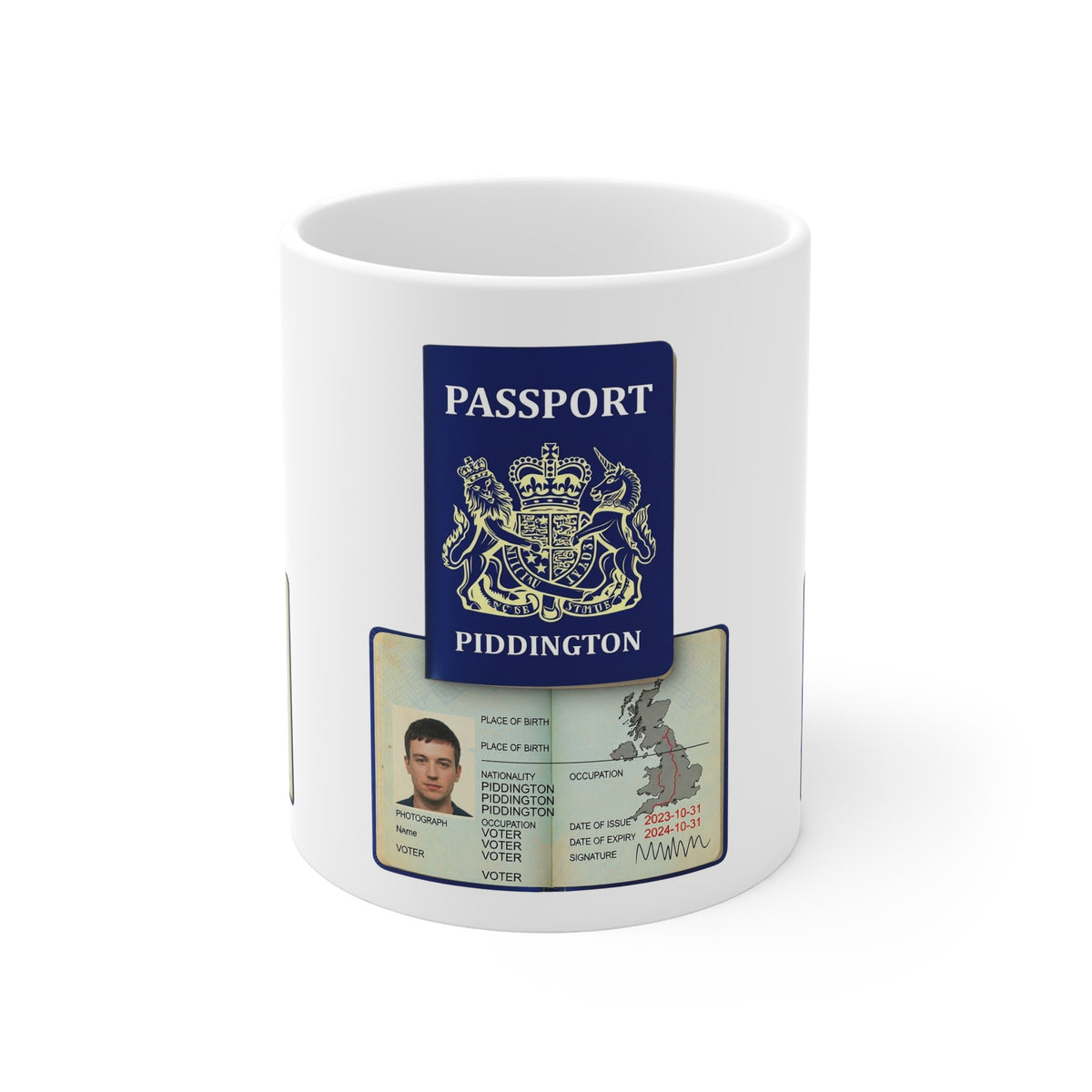White ceramic mug printed with a mock Piddington passport featuring the royal arms, nationality Piddington, occupation Voter and a passport photo, sitting on a wooden crate in front of villagers holding Save Piddington Voter Rights signs