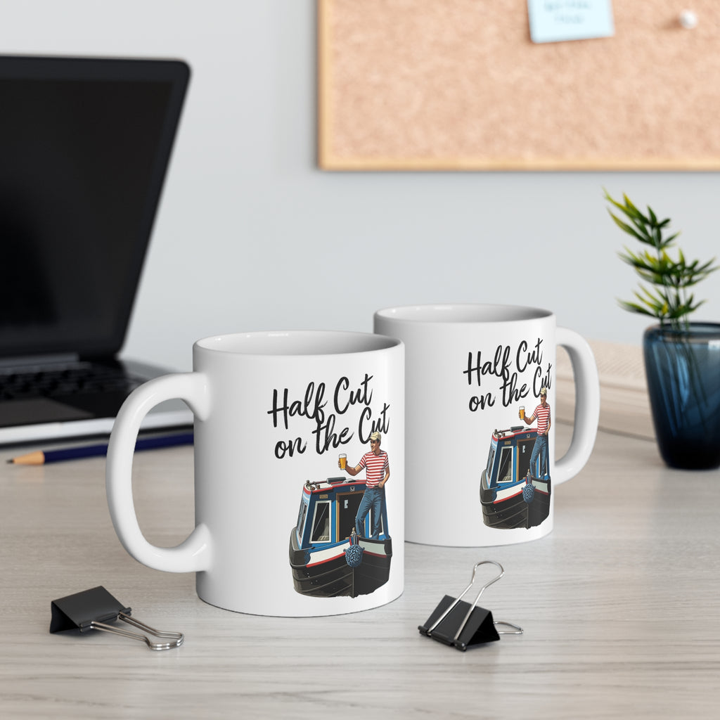 Two mugs with canal boat design and text on a desk with office items.