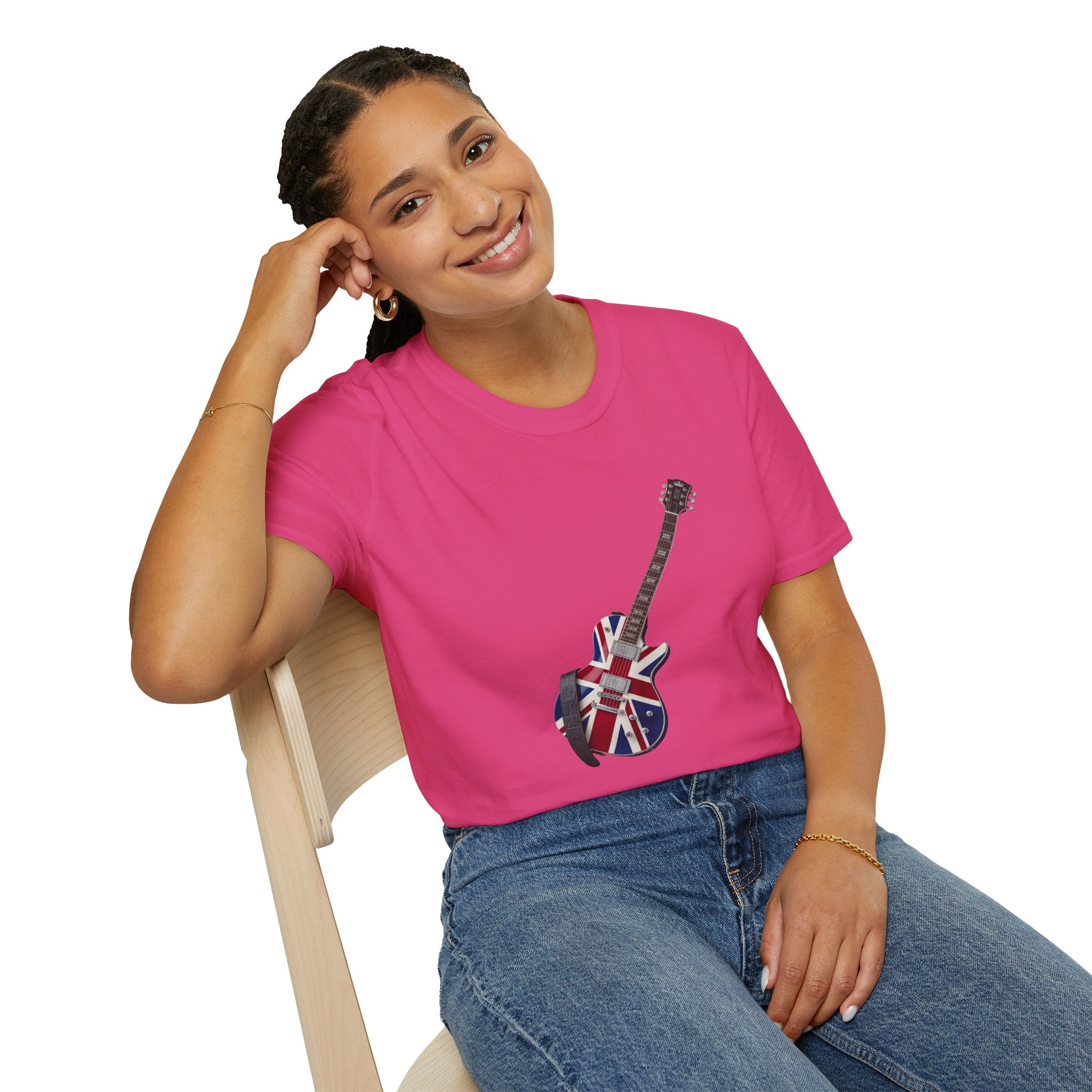 Person wearing a pink t-shirt with a guitar design featuring the British flag, sitting on a chair.