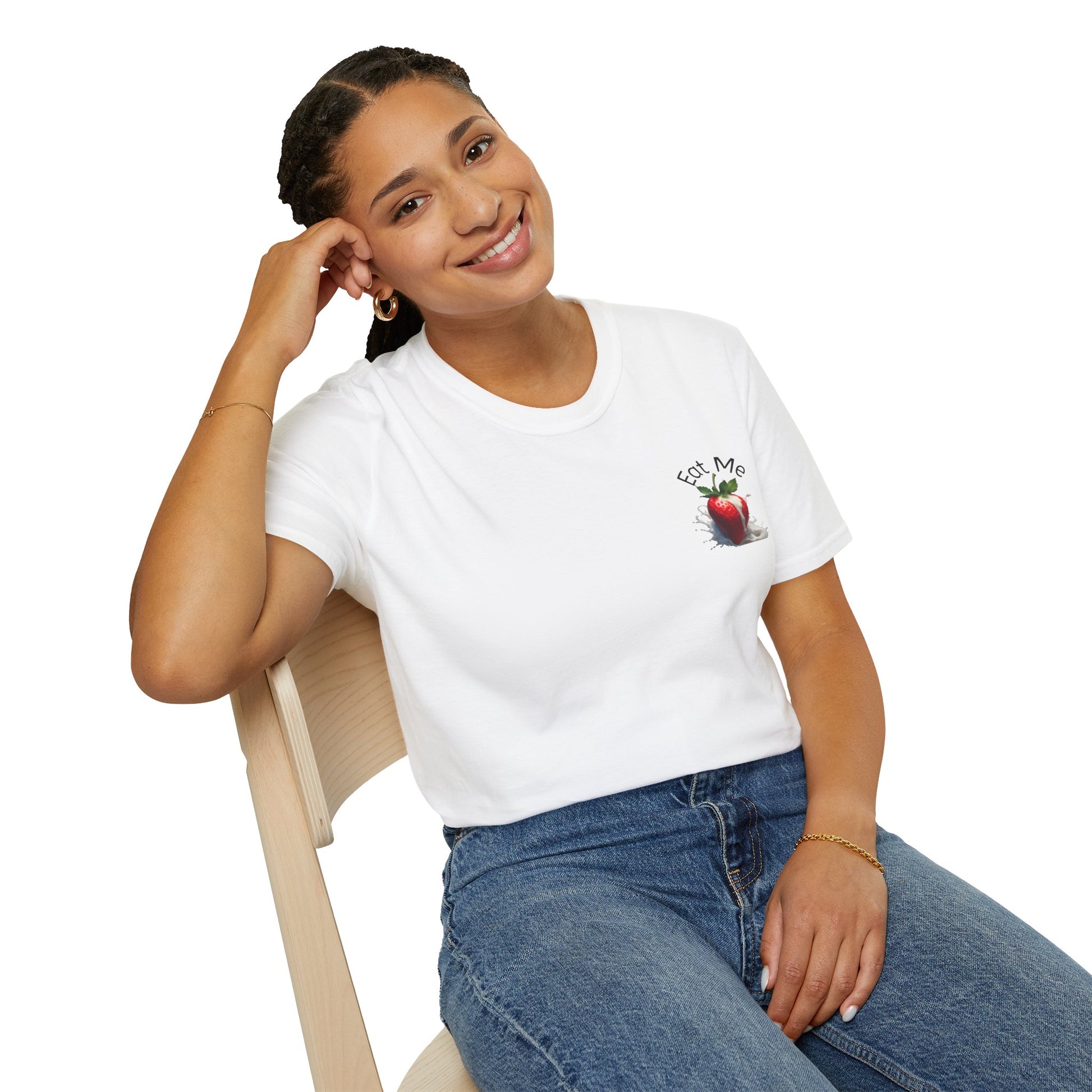 Woman wearing a white t-shirt with a graphic design sitting on a chair.