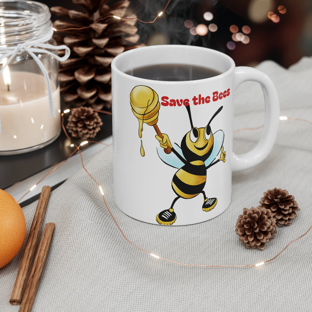 White mug with a bee design and 'Save the Bees' text, surrounded by decorative items on a table.
