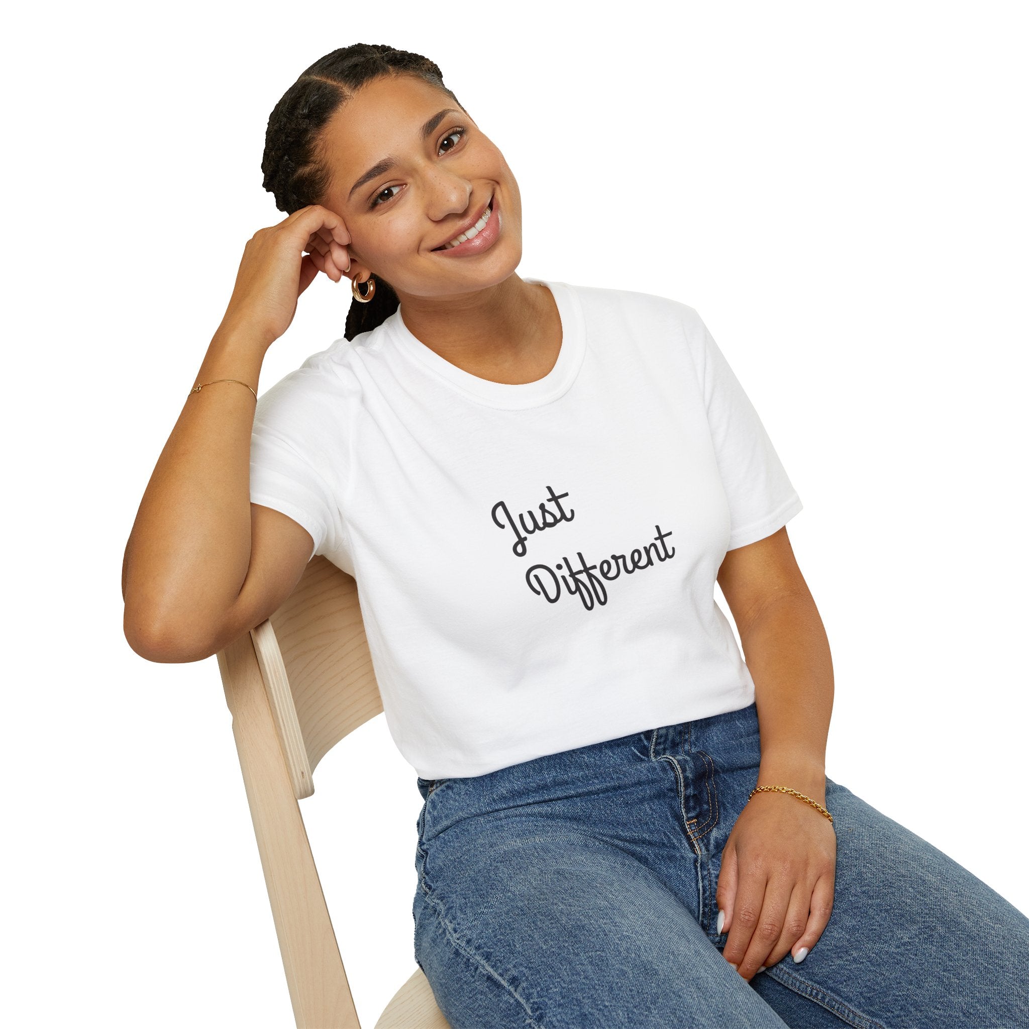 Person wearing a white t-shirt with 'Just Different' text, sitting on a chair.