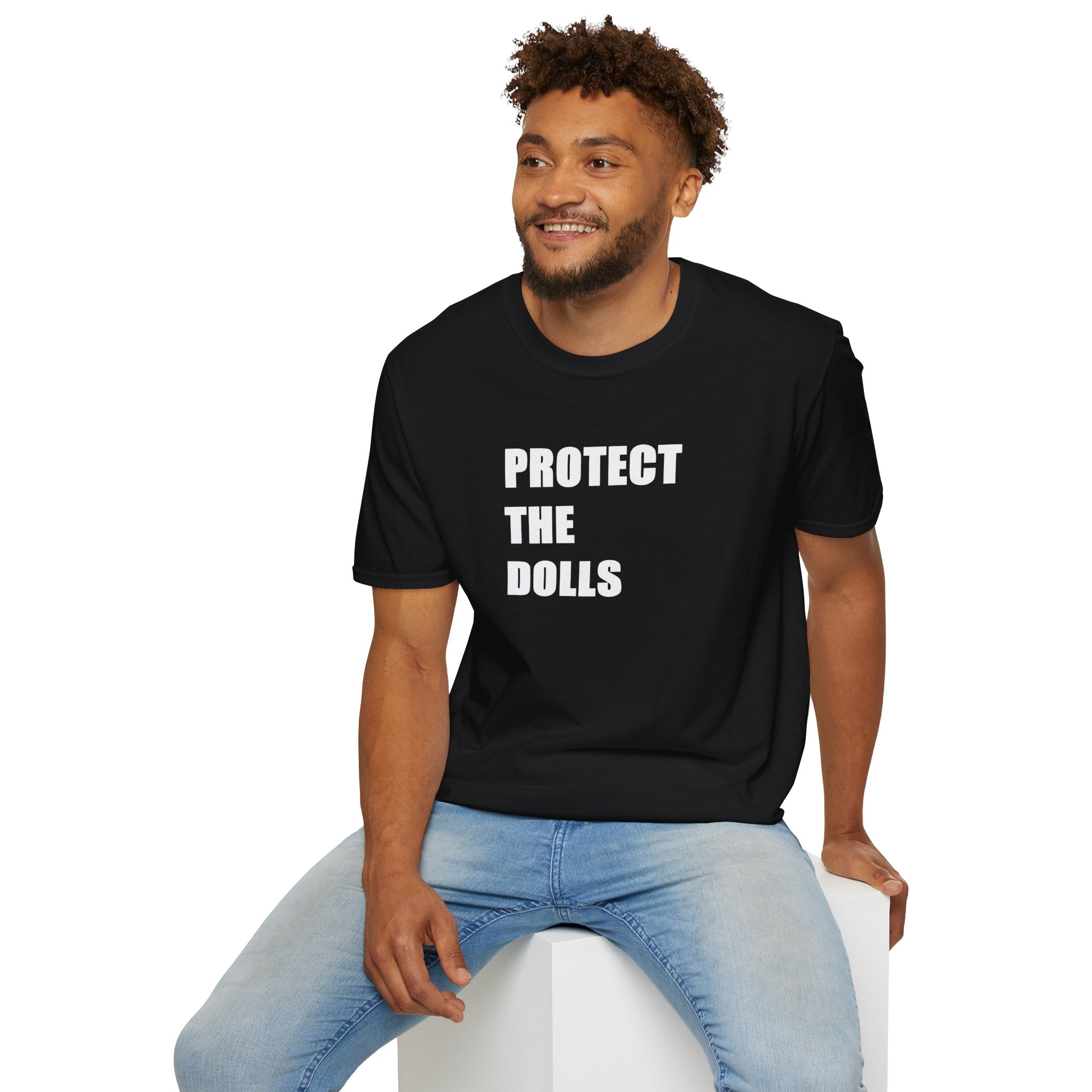 Man wearing a black t-shirt with 'PROTECT THE DOLLS' text on a white background