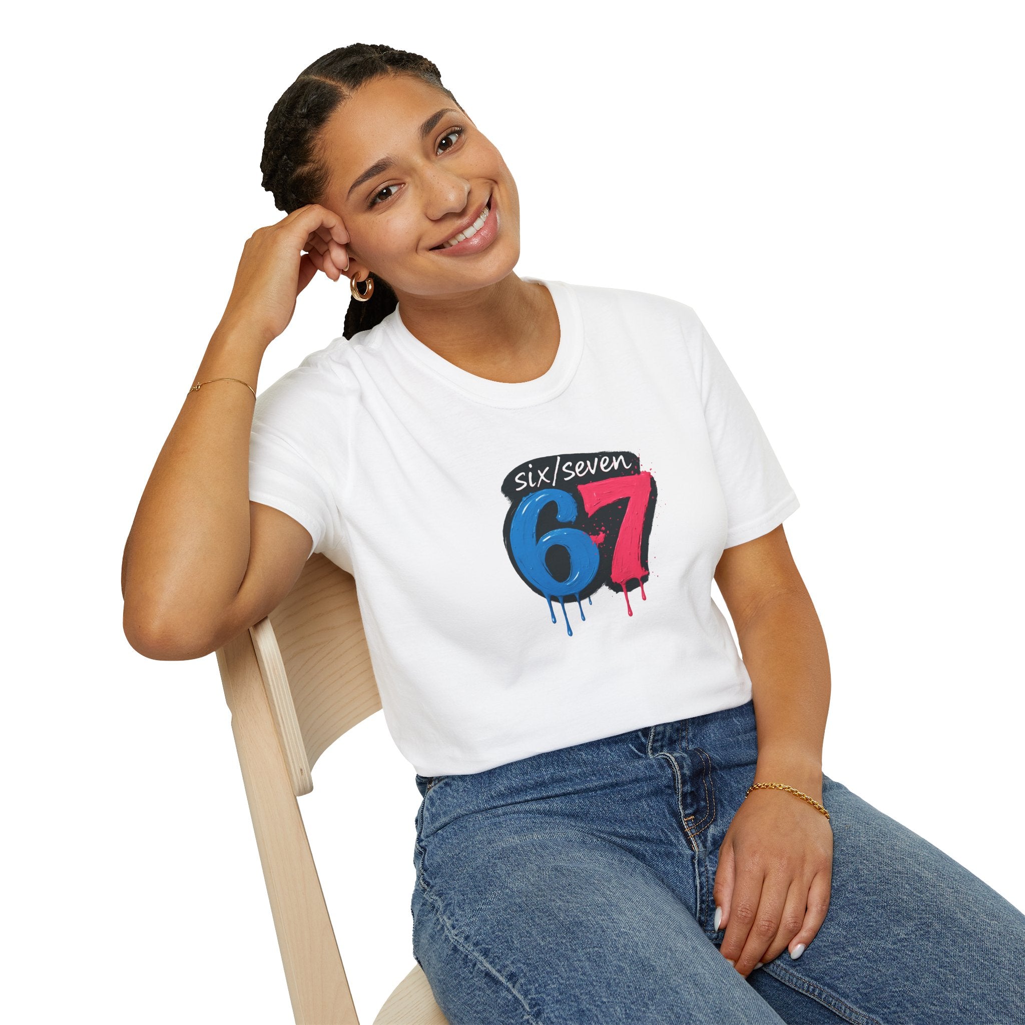 Person wearing a white t-shirt with colourful  six seven meme design sitting on a chair.