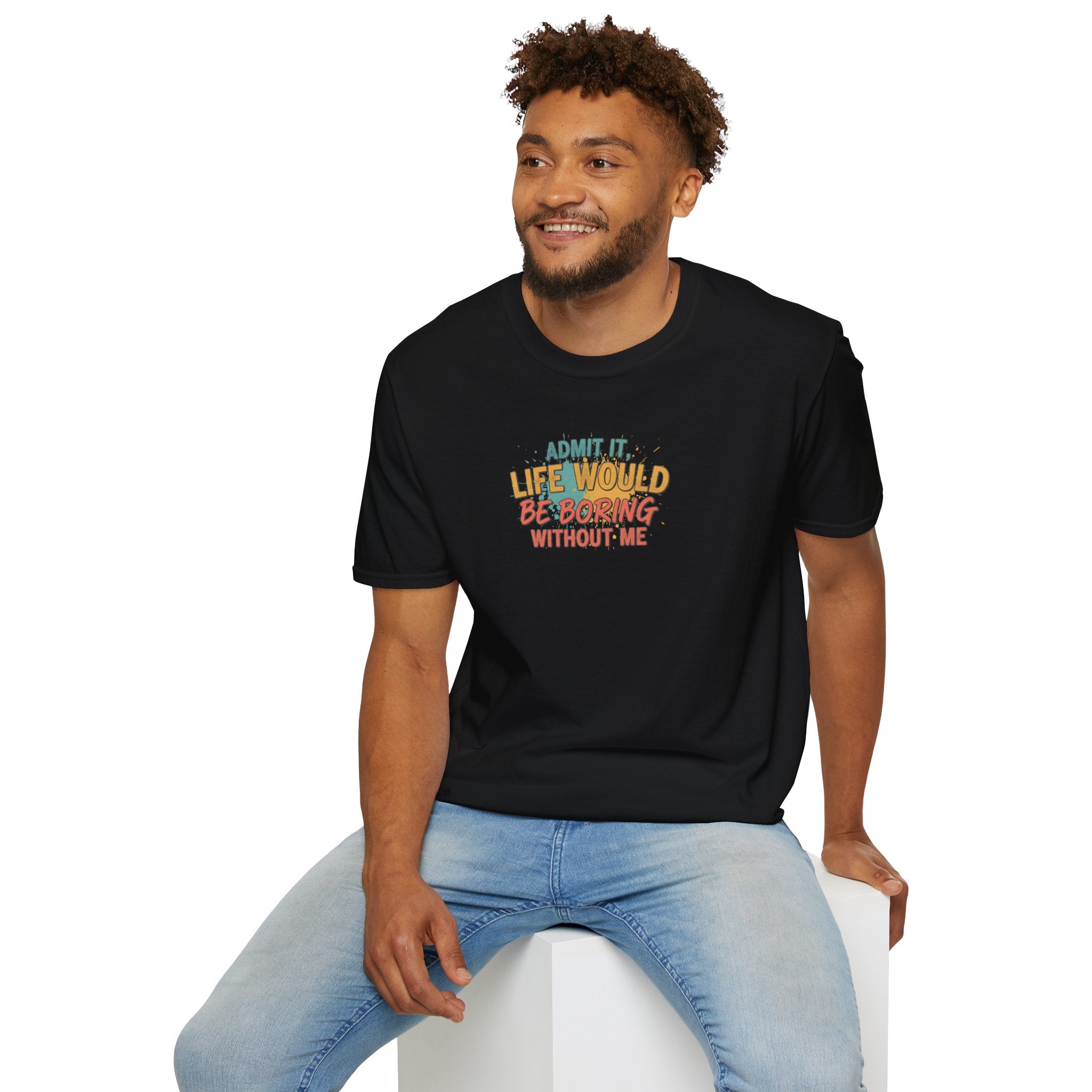 Man wearing a black t-shirt with colorful text sitting on a white stool against a white background