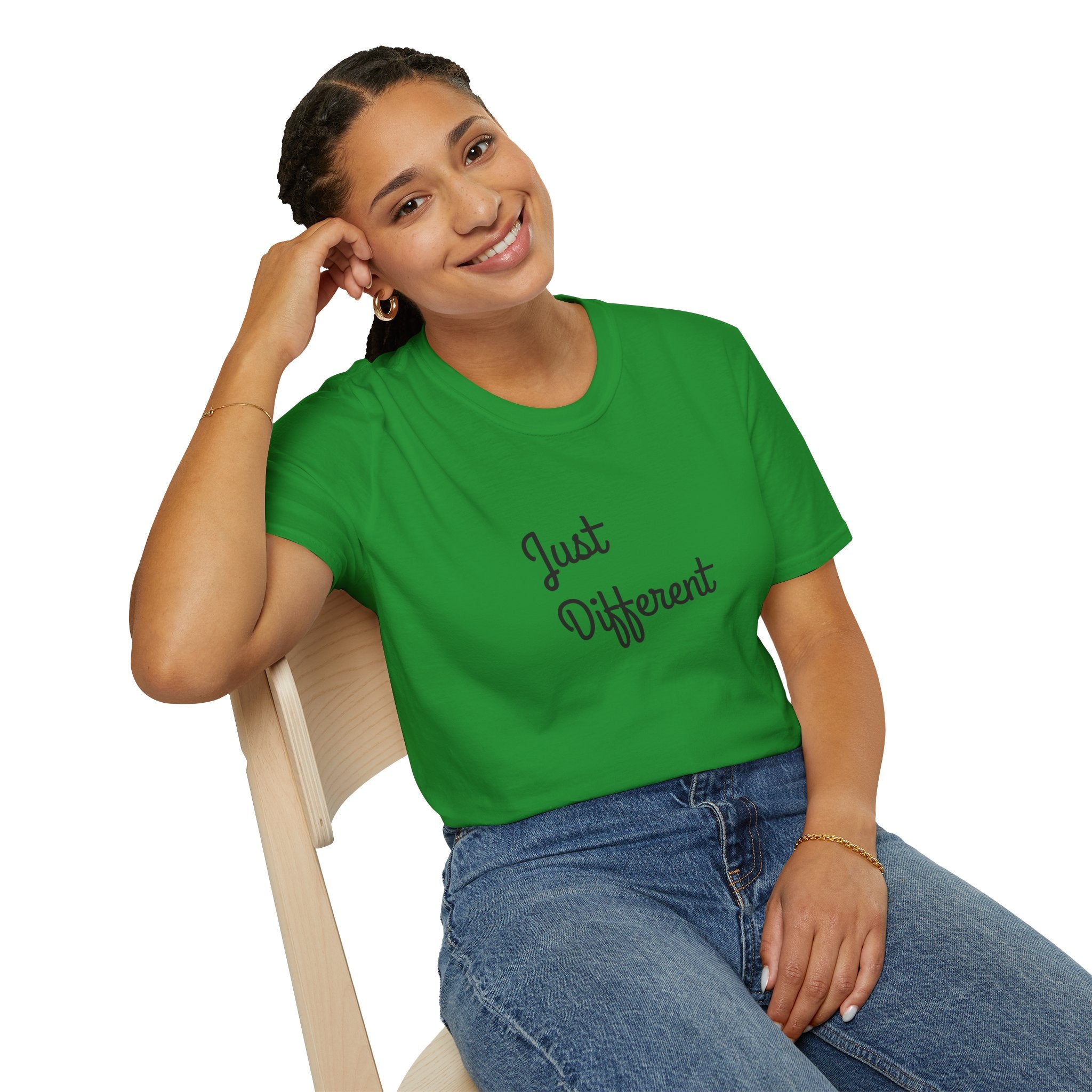 Person wearing a green t-shirt with 'Just Different' text, sitting on a chair.