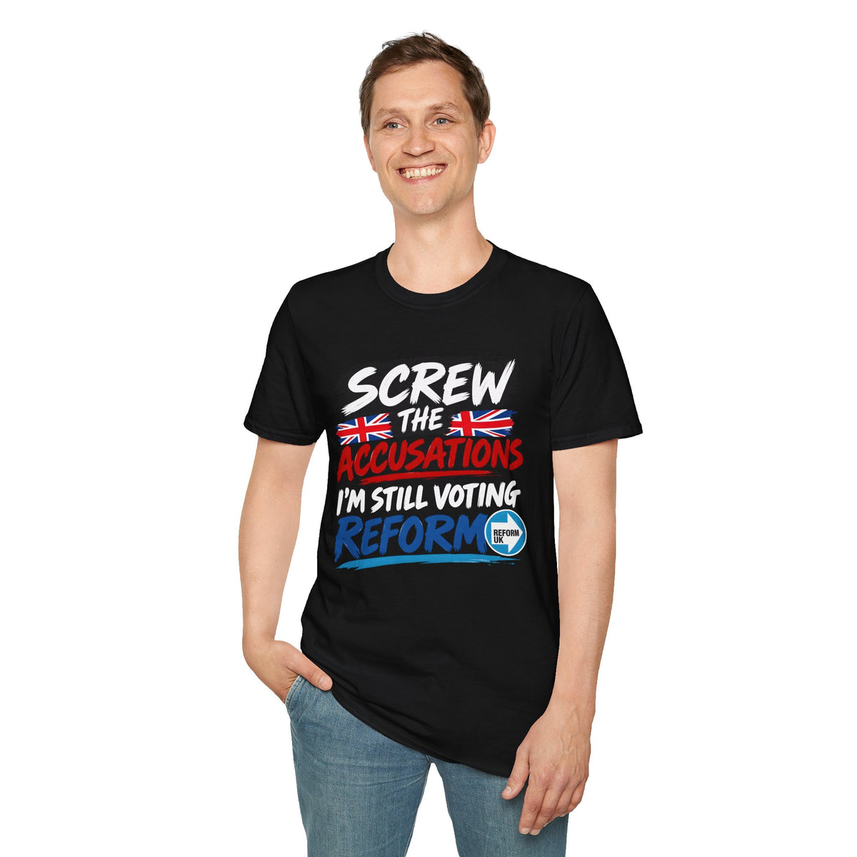 A man wearing a black graphic t-shirt with the text 'SCREW THE ACCUSATIONS I'M STILL VOTING REFORM' in white, red, and blue, paired with blue jeans, against a plain white background.