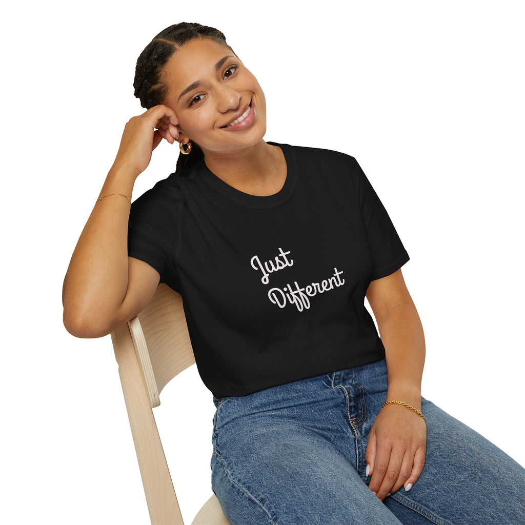Woman wearing a black t-shirt with 'Just Different' text, sitting on a chair.