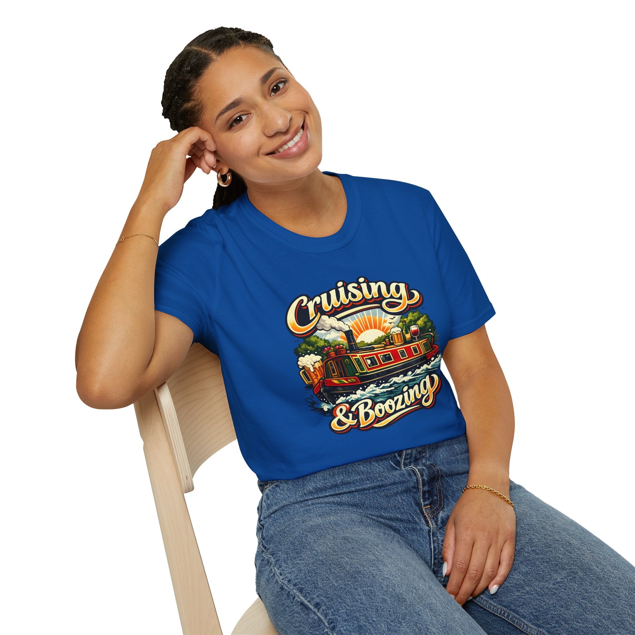 Person wearing a blue t-shirt with 'Cruising & Boozing' design, sitting on a chair.