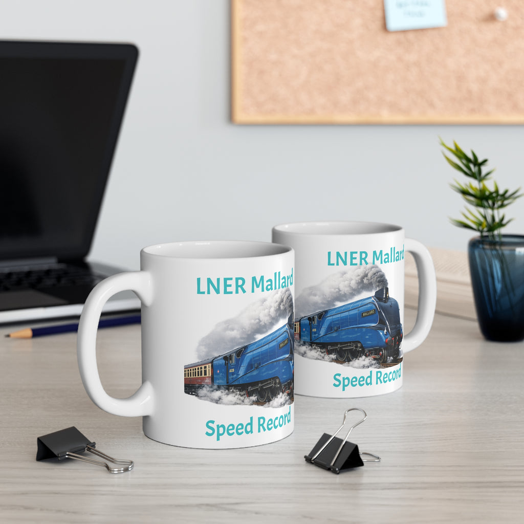 Two mugs with LNER Mallard design on a desk with a laptop and plant.