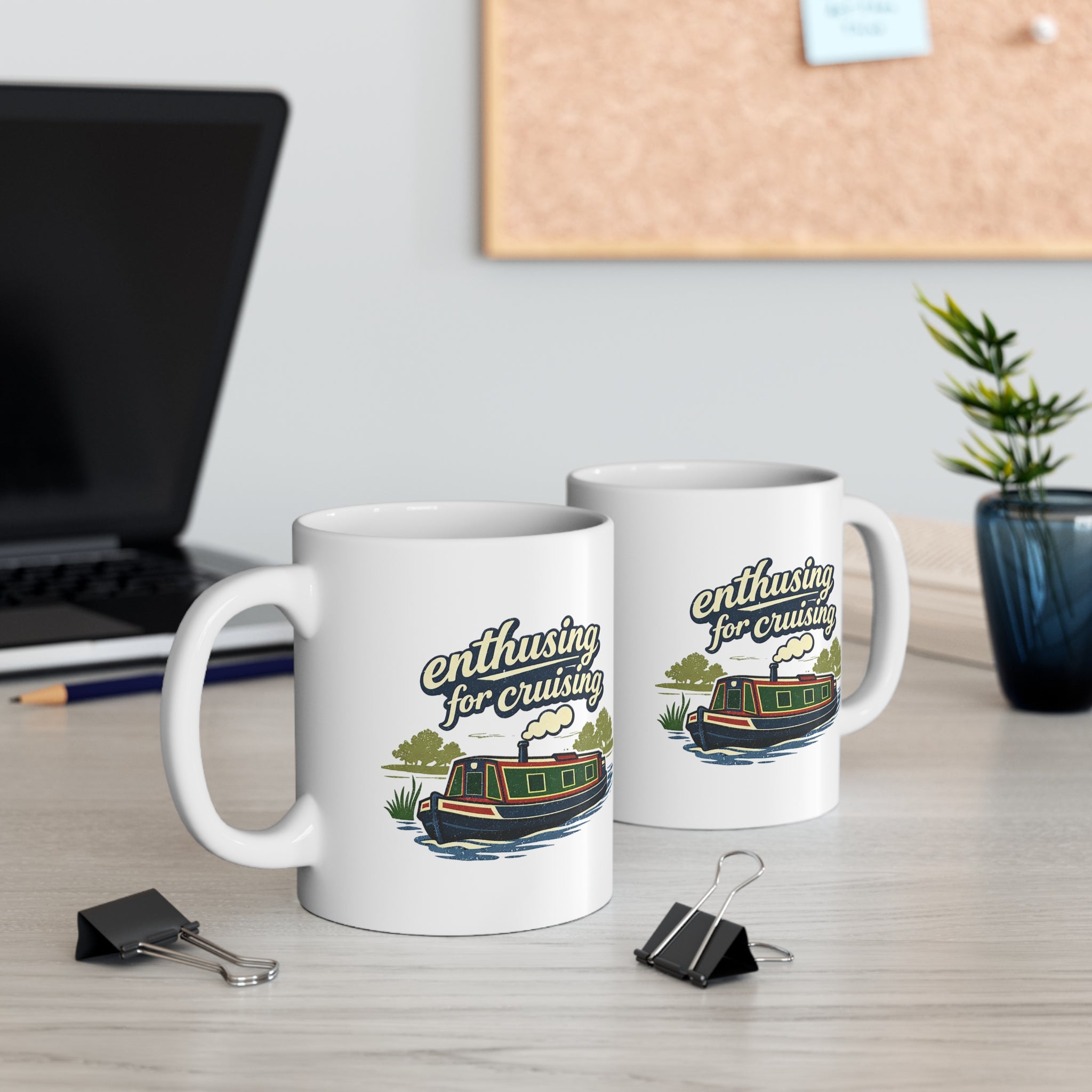 Two mugs with 'enthusiastic for cruising' design on a desk with office items.