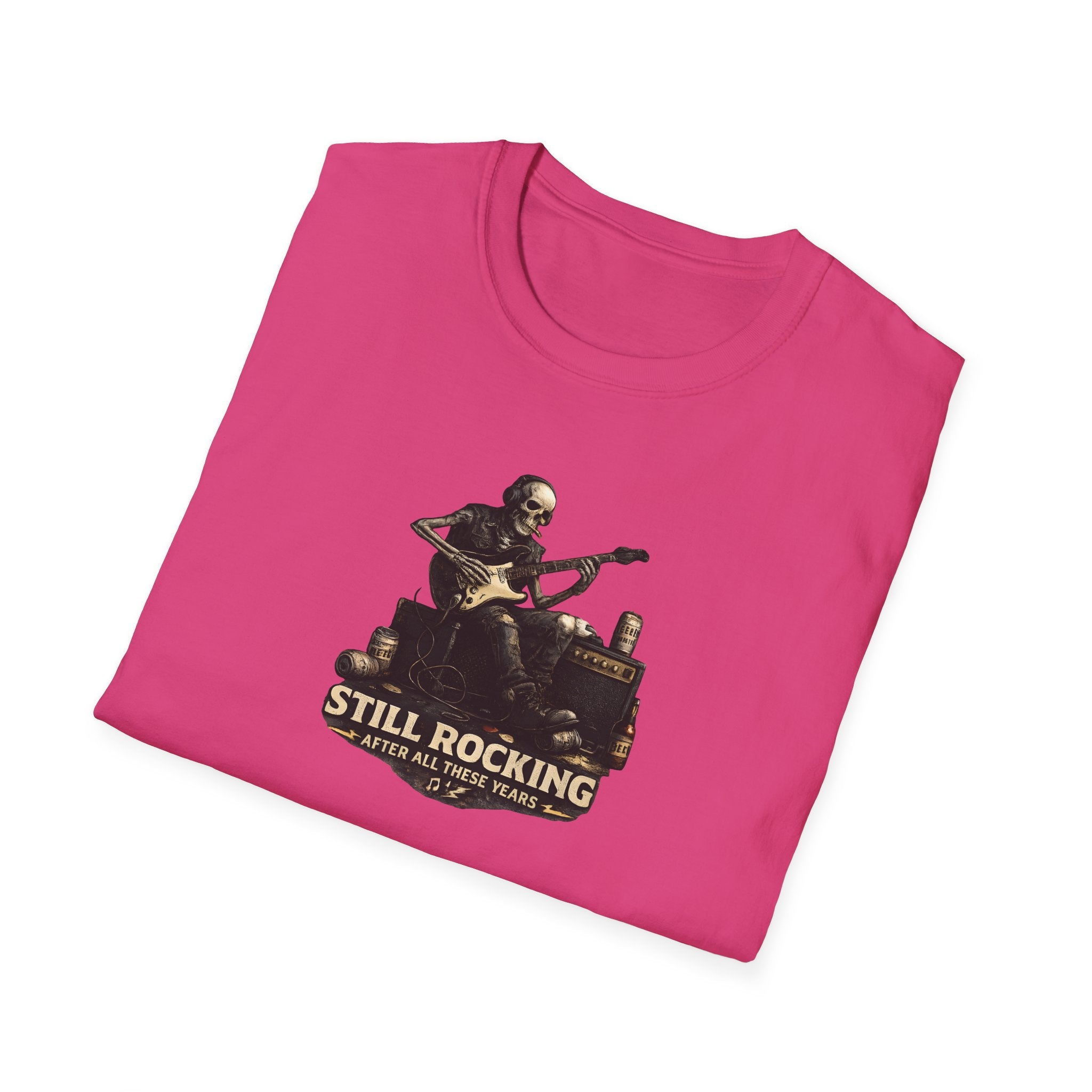 Pink t-shirt with a graphic of a skeleton playing guitar and text 'Still Rocking After All These Years' on a white background.