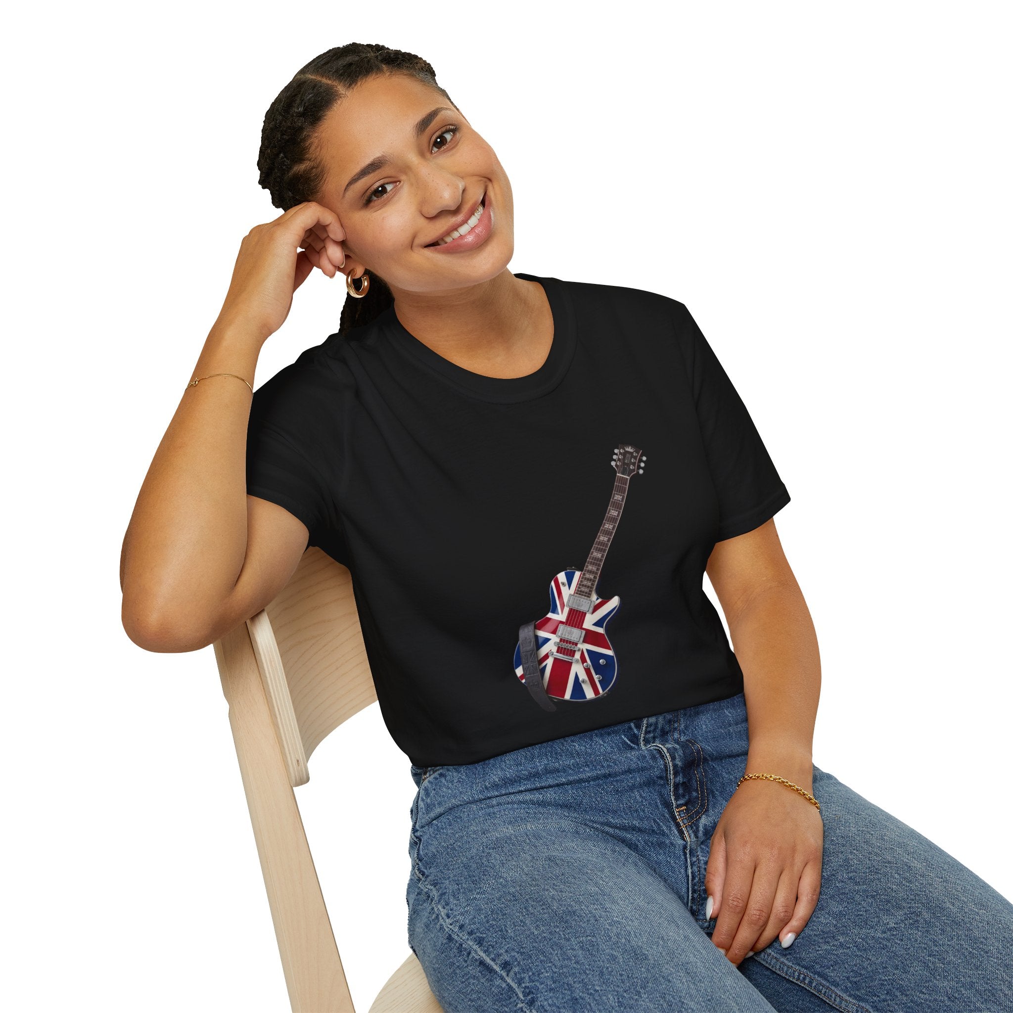 Person wearing a black t-shirt with a guitar design featuring the British flag, sitting on a chair.