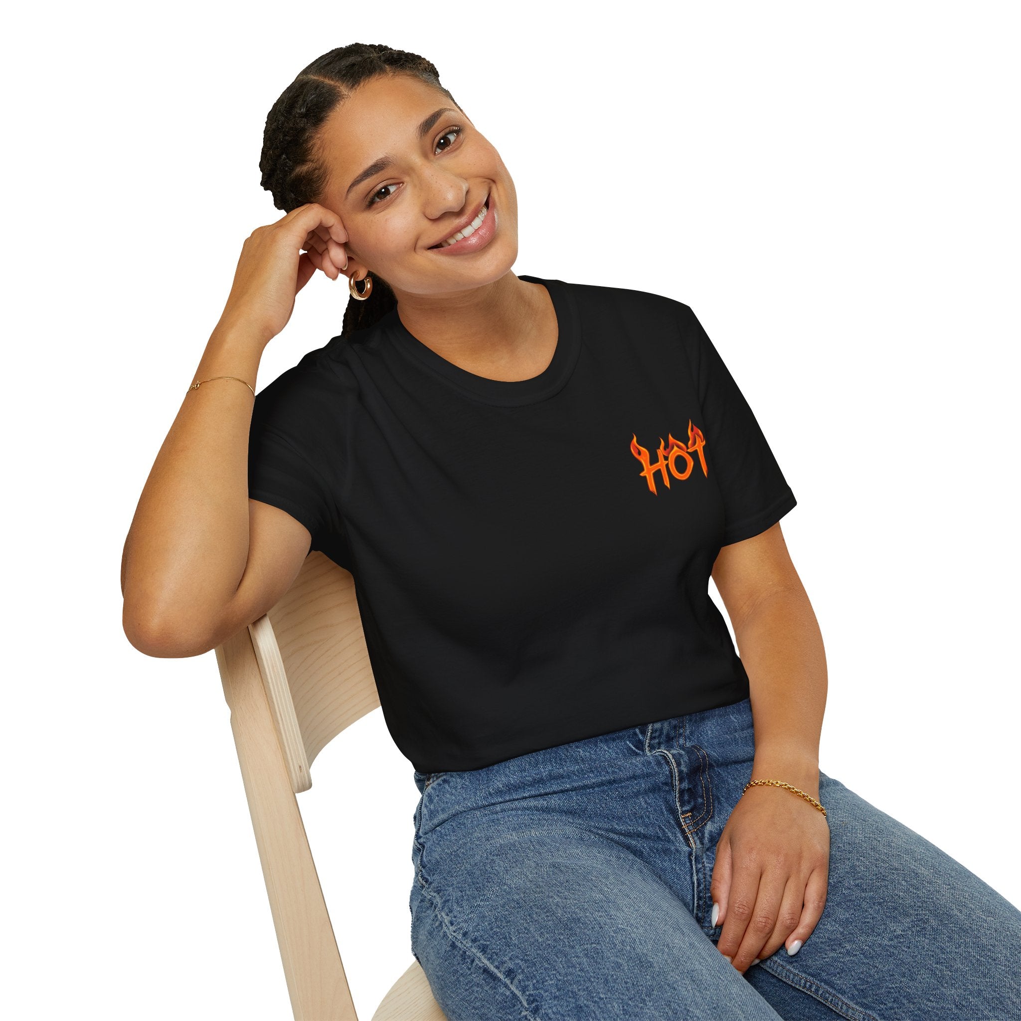 Woman wearing a black t-shirt with an orange "hot" logo, sitting on a chair against a white background