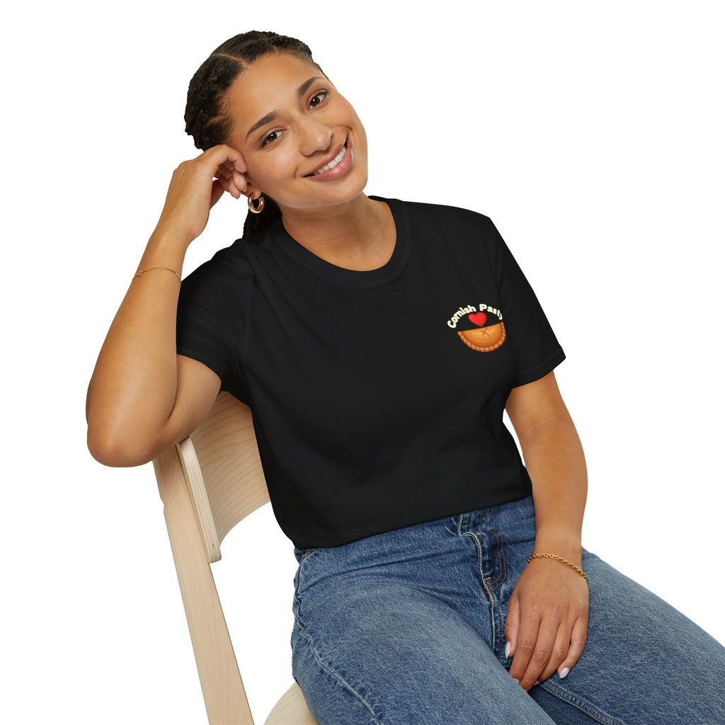 Woman wearing a black t-shirt with a Cornish pasty logo, sitting on a chair against a white background 