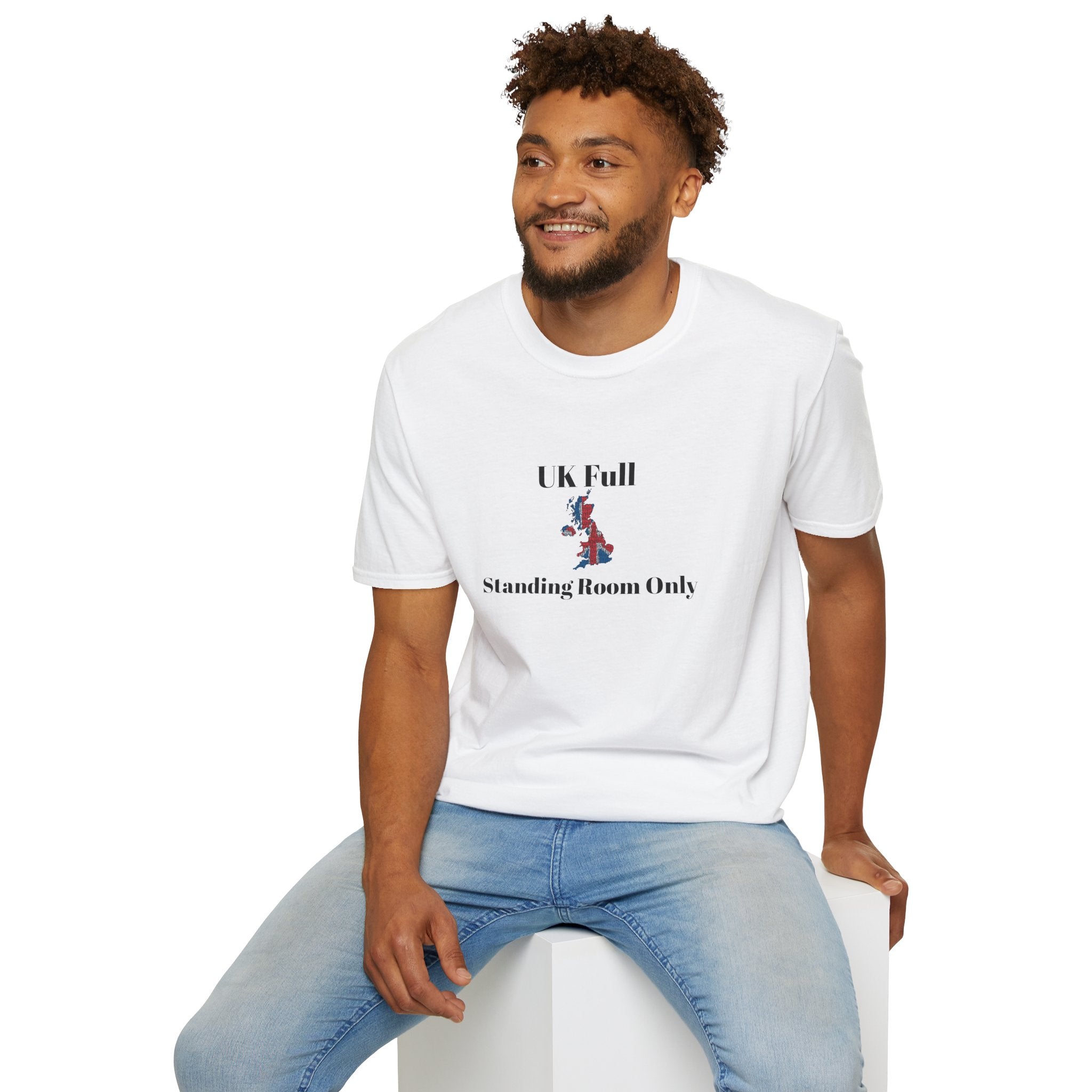 Man sitting wearing  White t shirt with a bold UK outline packed tight in Union Jack colours, text reads UK full, standing room only