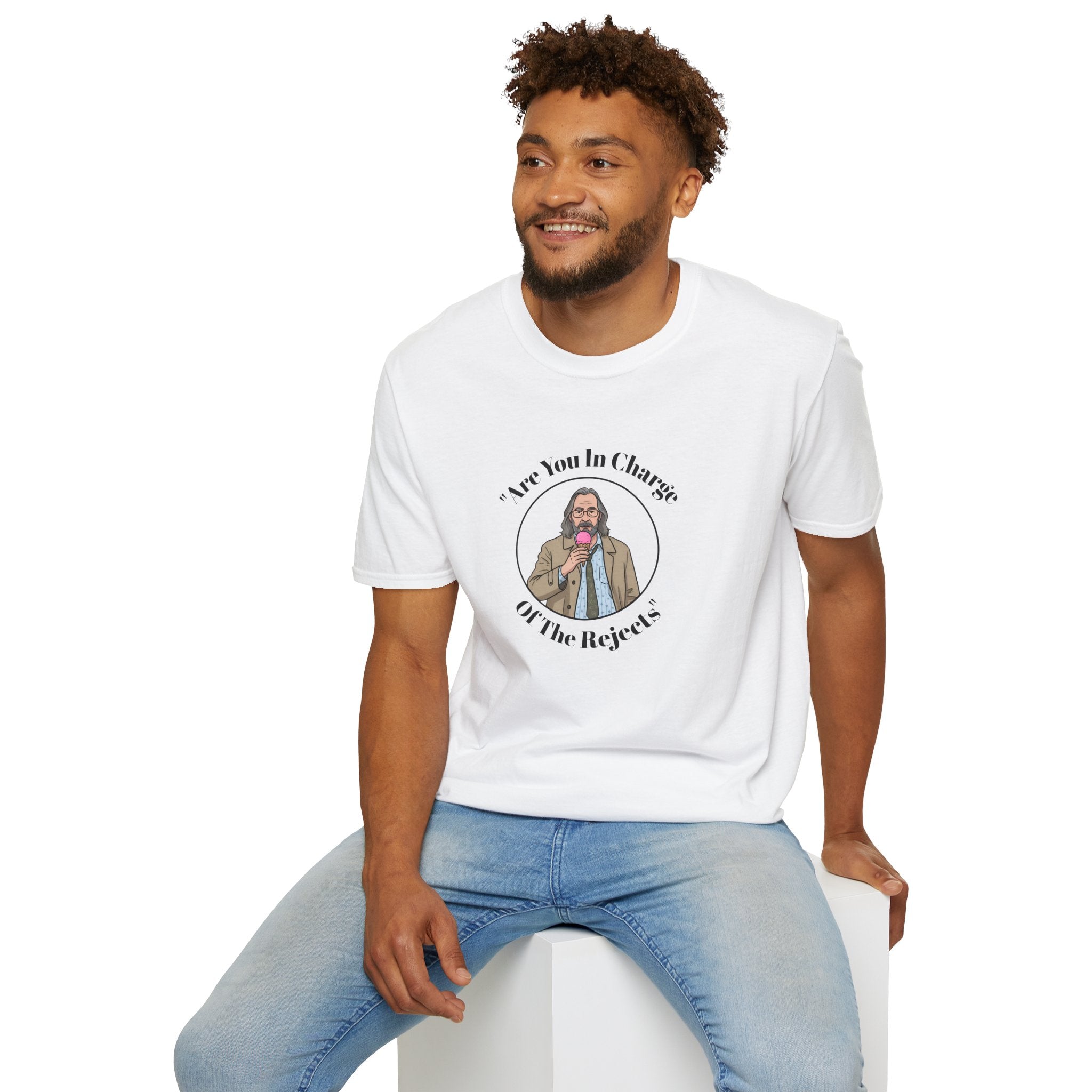 Man wearing a white t-shirt with a Jackson lamb graphic design sitting on a white stool against a white background