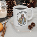 Jackson lamb White mug with a graphic design and text, surrounded by decorative items like a candle, cinnamon sticks, and pine cones.