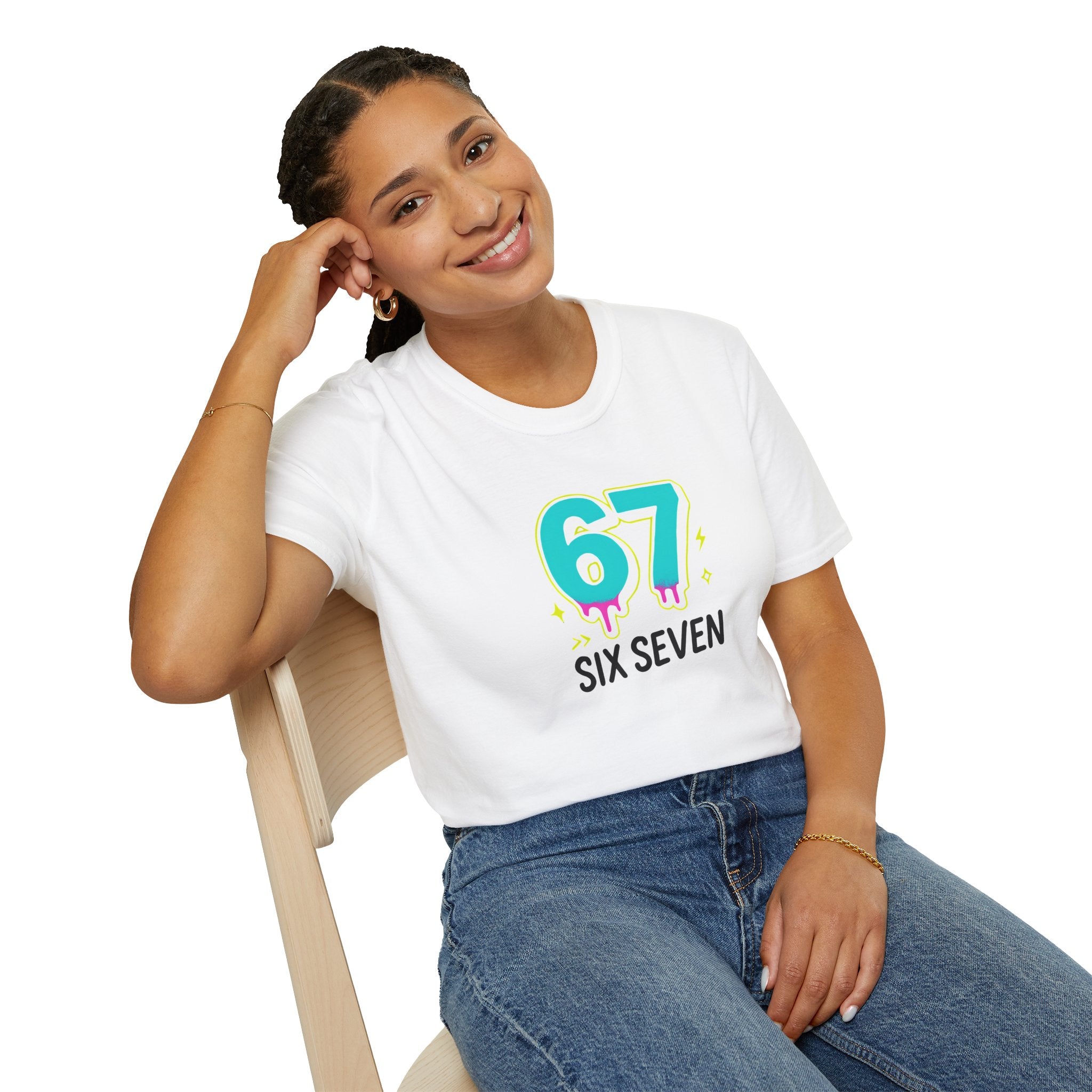 Person wearing a white t-shirt with colorful design sitting on a chair.