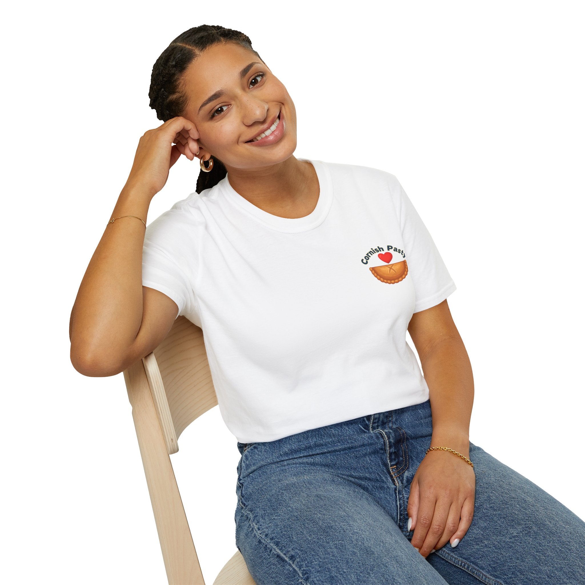 Woman wearing a white t-shirt with a Cornish pasty logo, sitting on a chair against a white background