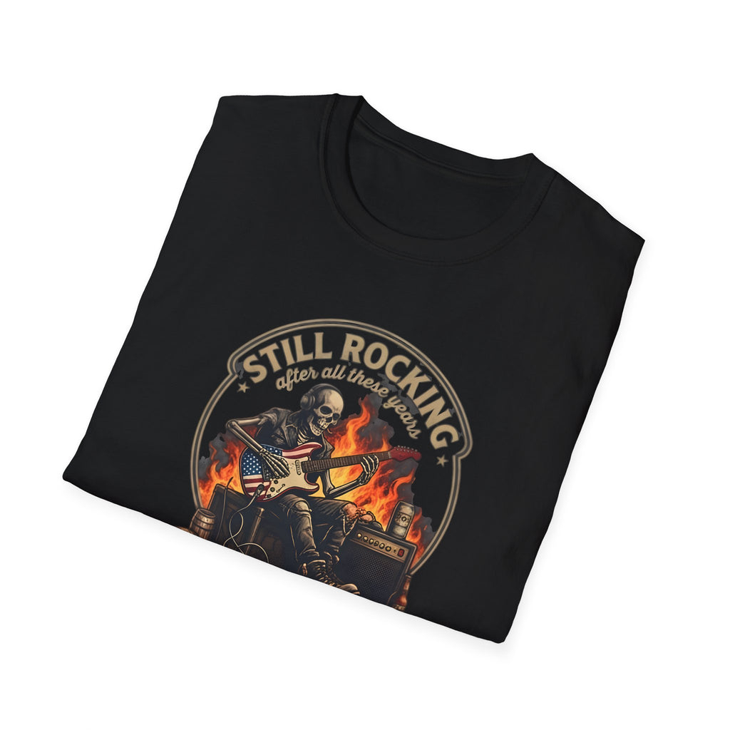 Black t-shirt with a graphic design of a skeleton playing guitar and text 'Still Rocking after all these years' on a white background.