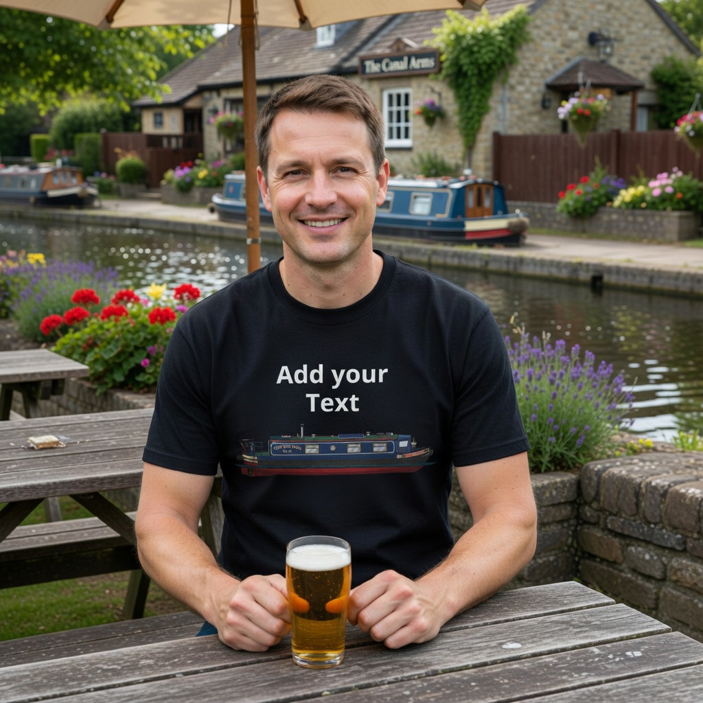 Man sitting at a table with a drink, wearing a black own boat personalised  t-shirt with text and a graphic, in a scenic outdoor setting. fat boris store