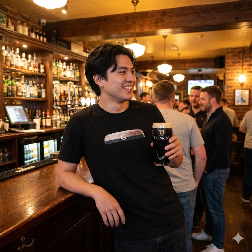 Man holding a Guinness beer in a pub setting GUINNESS G SPOT Graphic T-Shirt