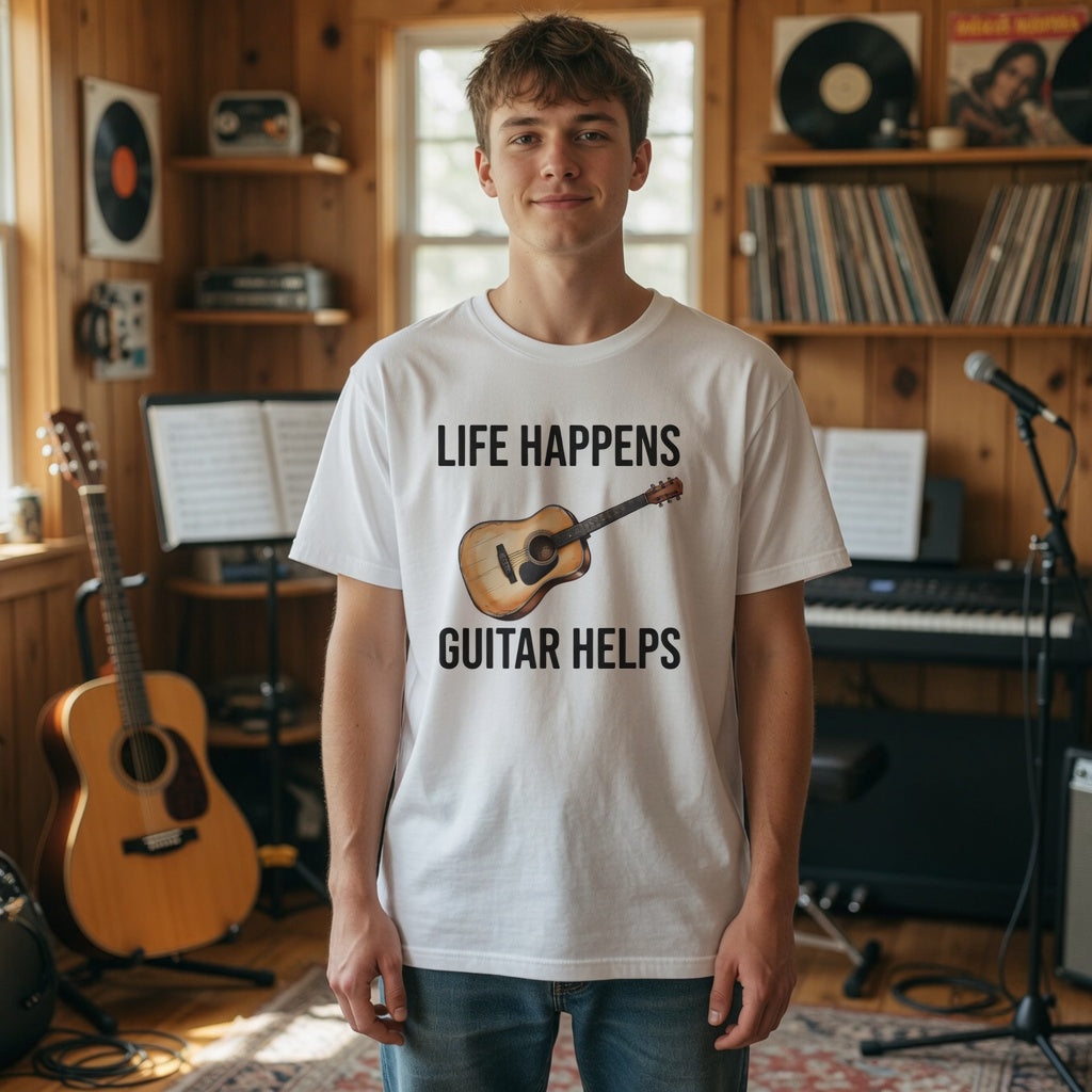 Person wearing a white t-shirt with 'Life happens, guitar helps' design in a music room.