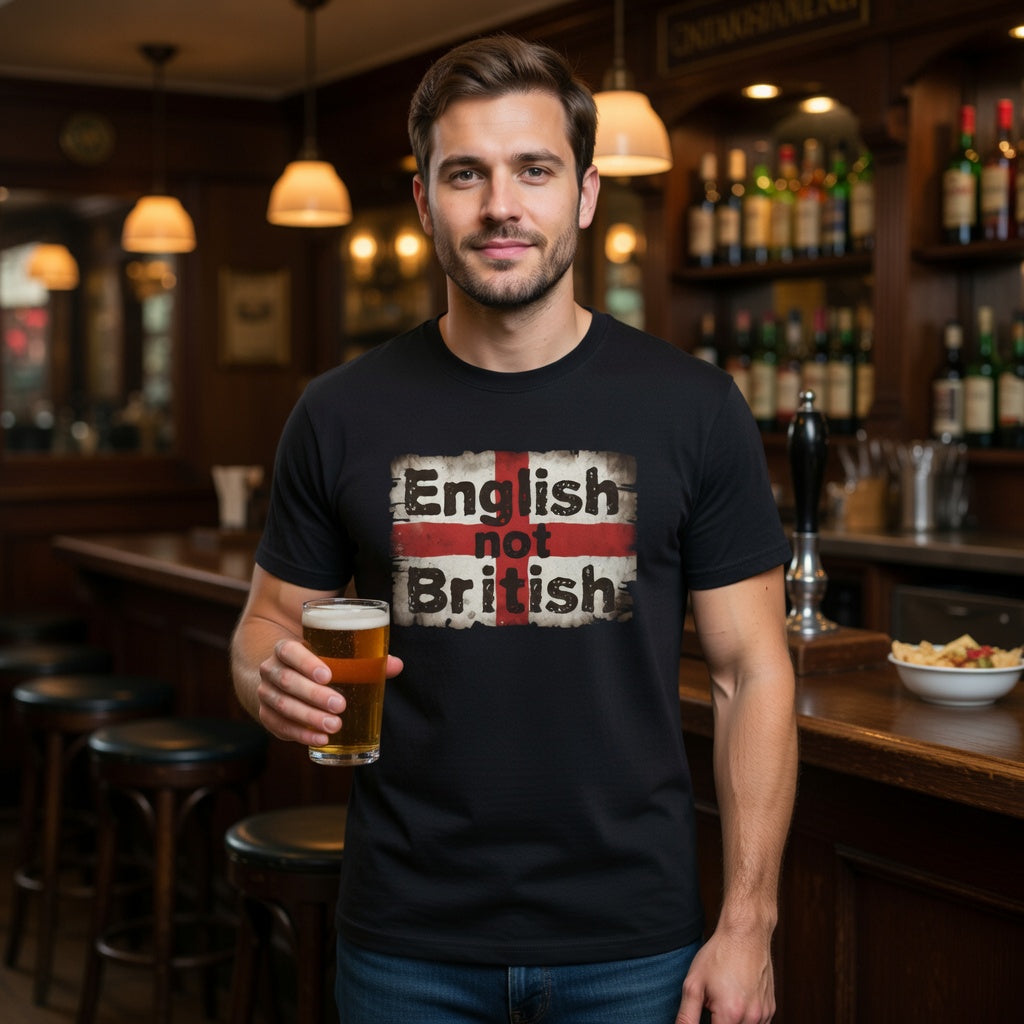 Man holding a beer in a pub wearing a black t-shirt with 'English not British' design.